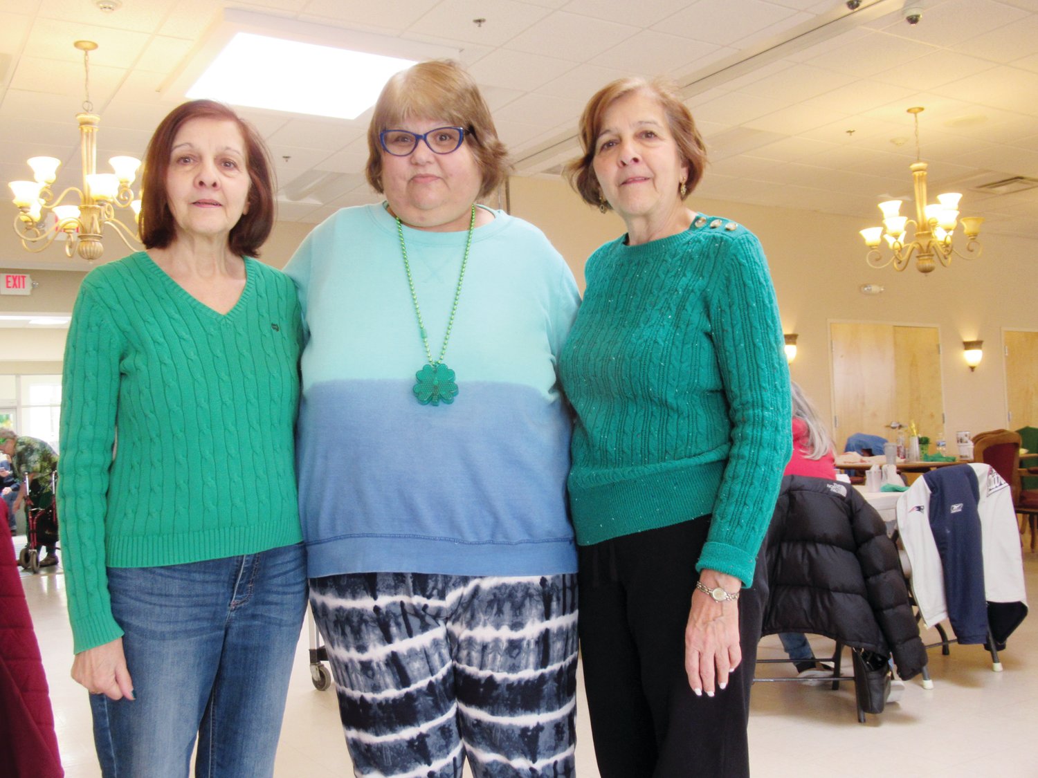 GREEN GALS: Twin sisters Judy Santilli (left) and Jeanne LaFazia (right) joined Debbie Quiles enjoy a mighty moment during last week’s JSC St. Pat’s Party.